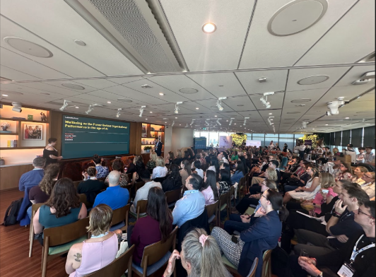 A packed audience watching Amanda Anderson present at the Wellbeing at Work Summit